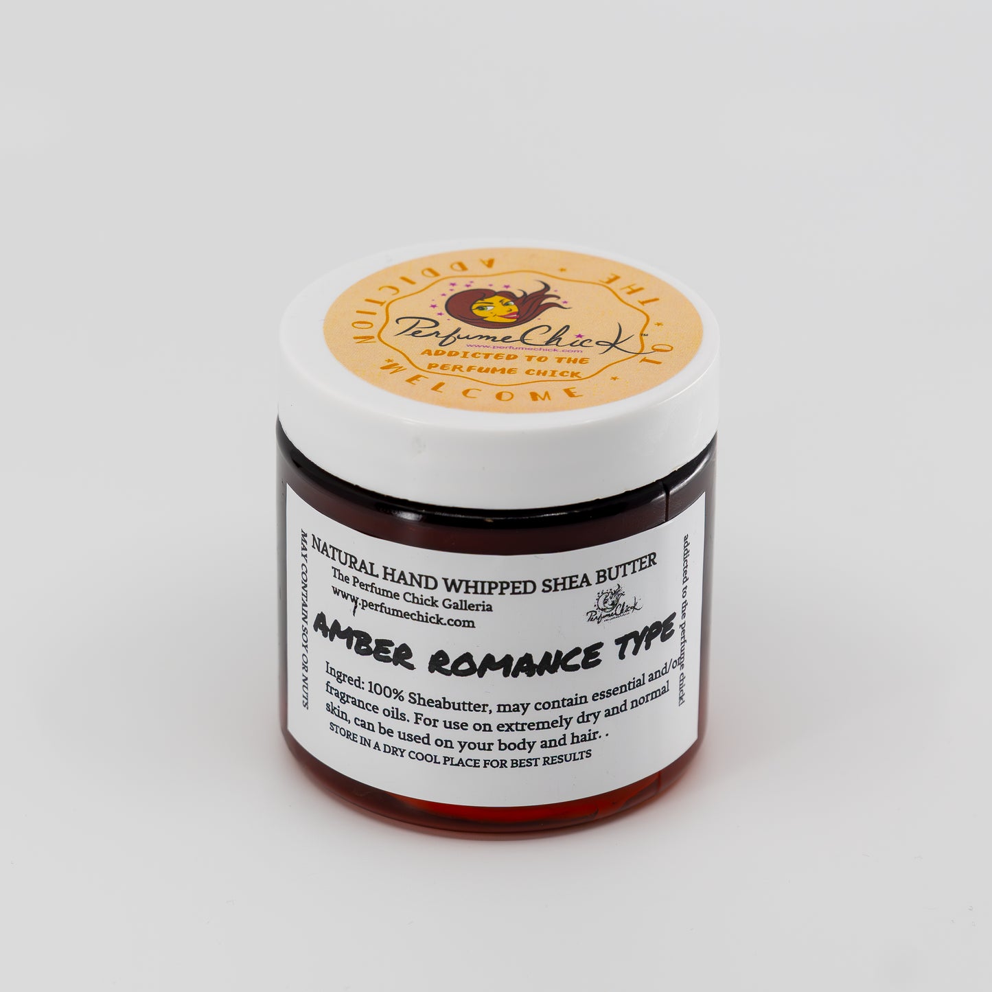 Jar of natural hand whipped shea butter with a white label on a light gray background