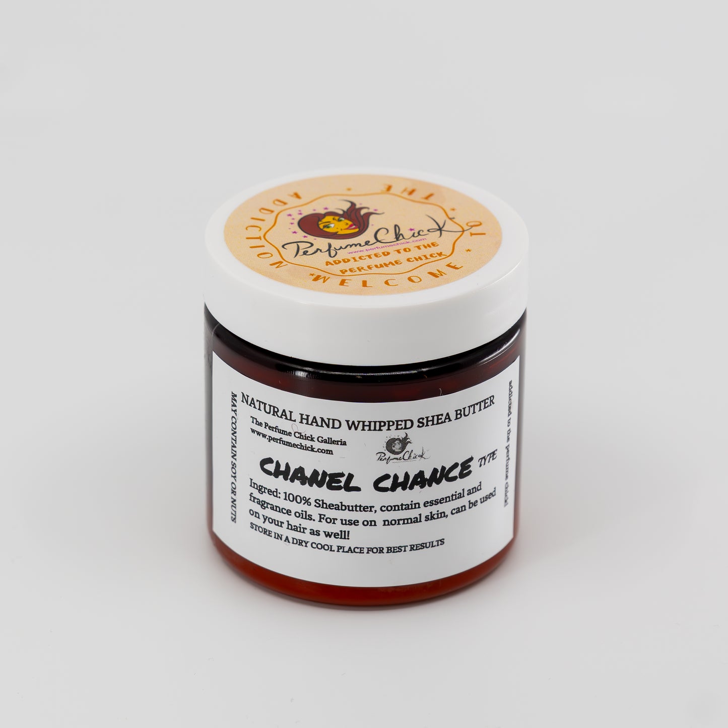 Jar of natural hand whipped shea butter with a visible label on a white background