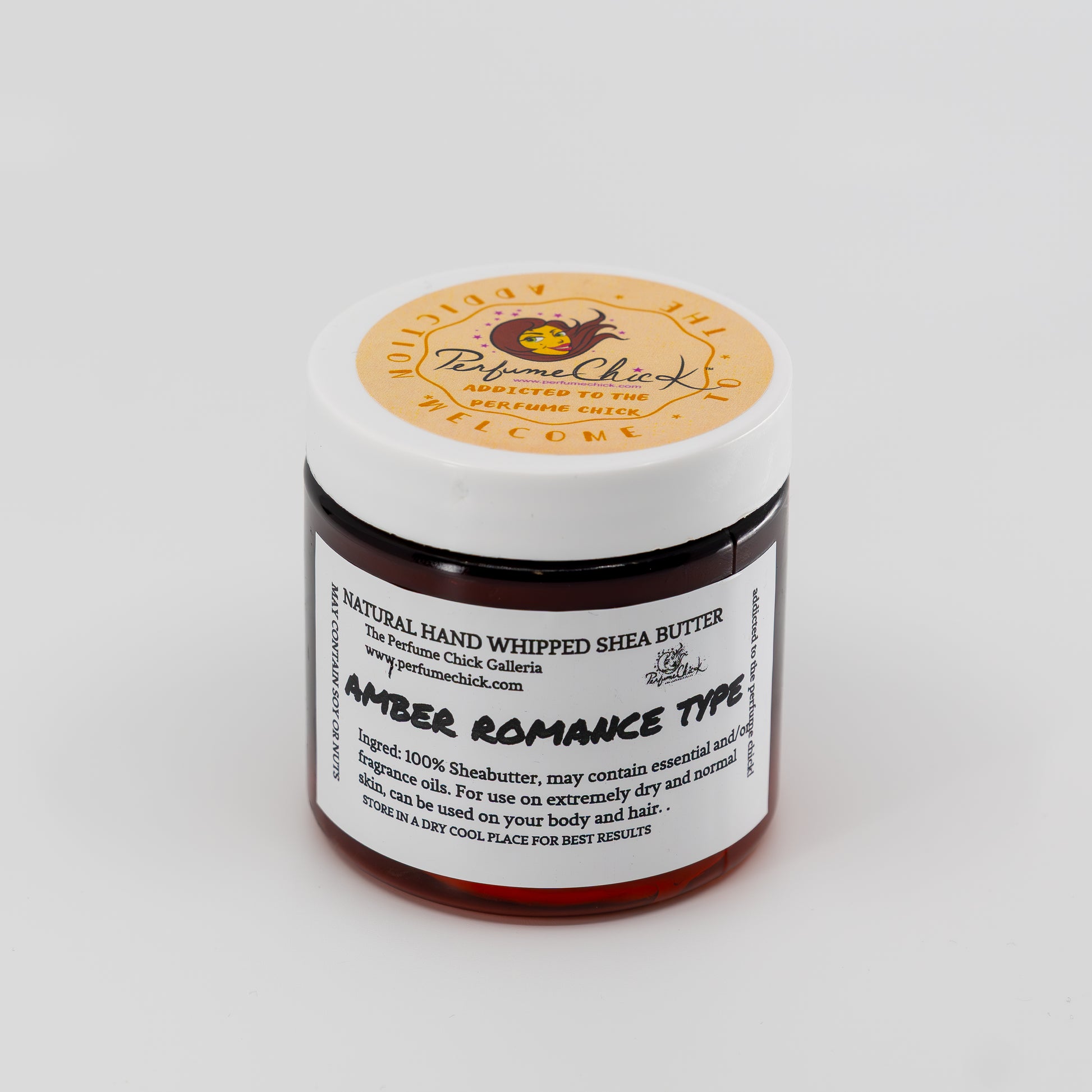 Jar of natural hand whipped shea butter with a white label on a light gray background