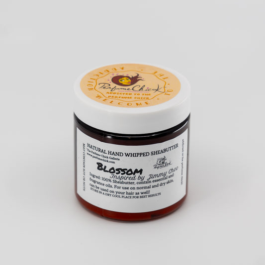 Jar of natural hand whipped shea butter with a visible label on a white background