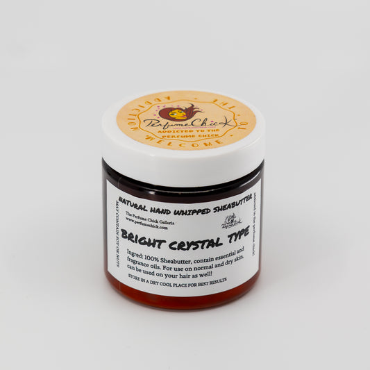 Jar of natural hand whipped shea butter with a label on a white background