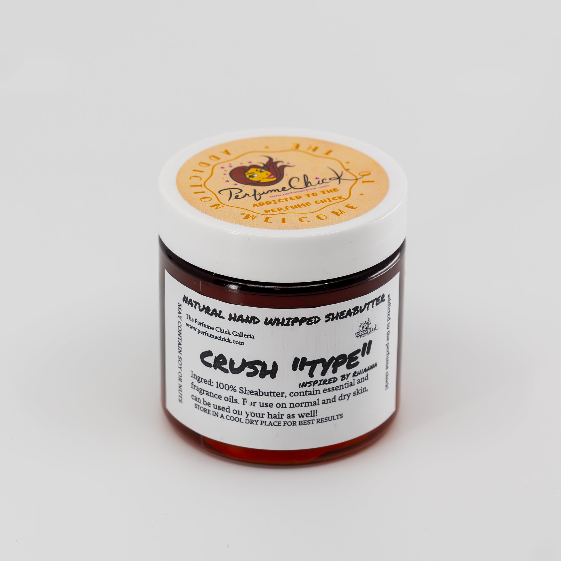 Jar of natural hand whipped shea butter with a visible brand label on a white background