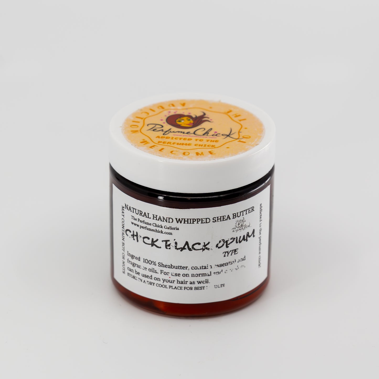 Jar of natural hand whipped shea butter with a visible label on a white background