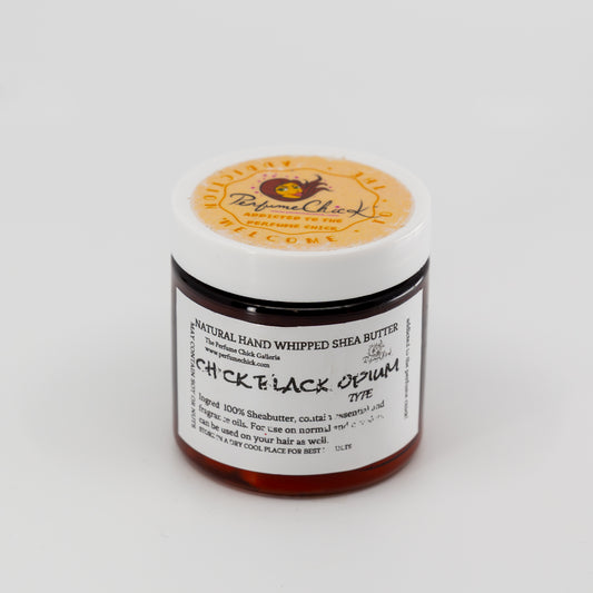 Jar of natural hand whipped shea butter with a visible label on a white background