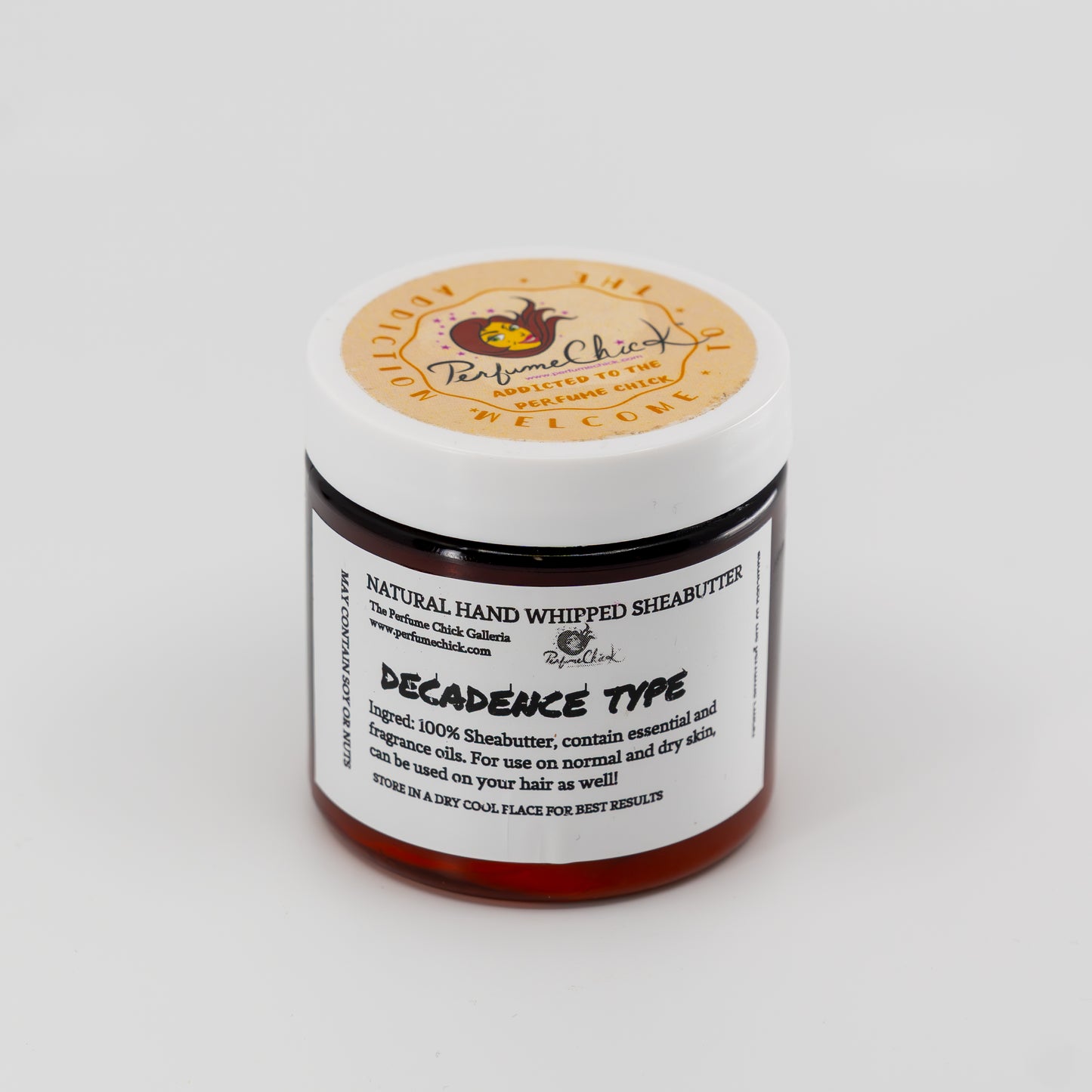 Jar of natural hand whipped shea butter with a label on a white background