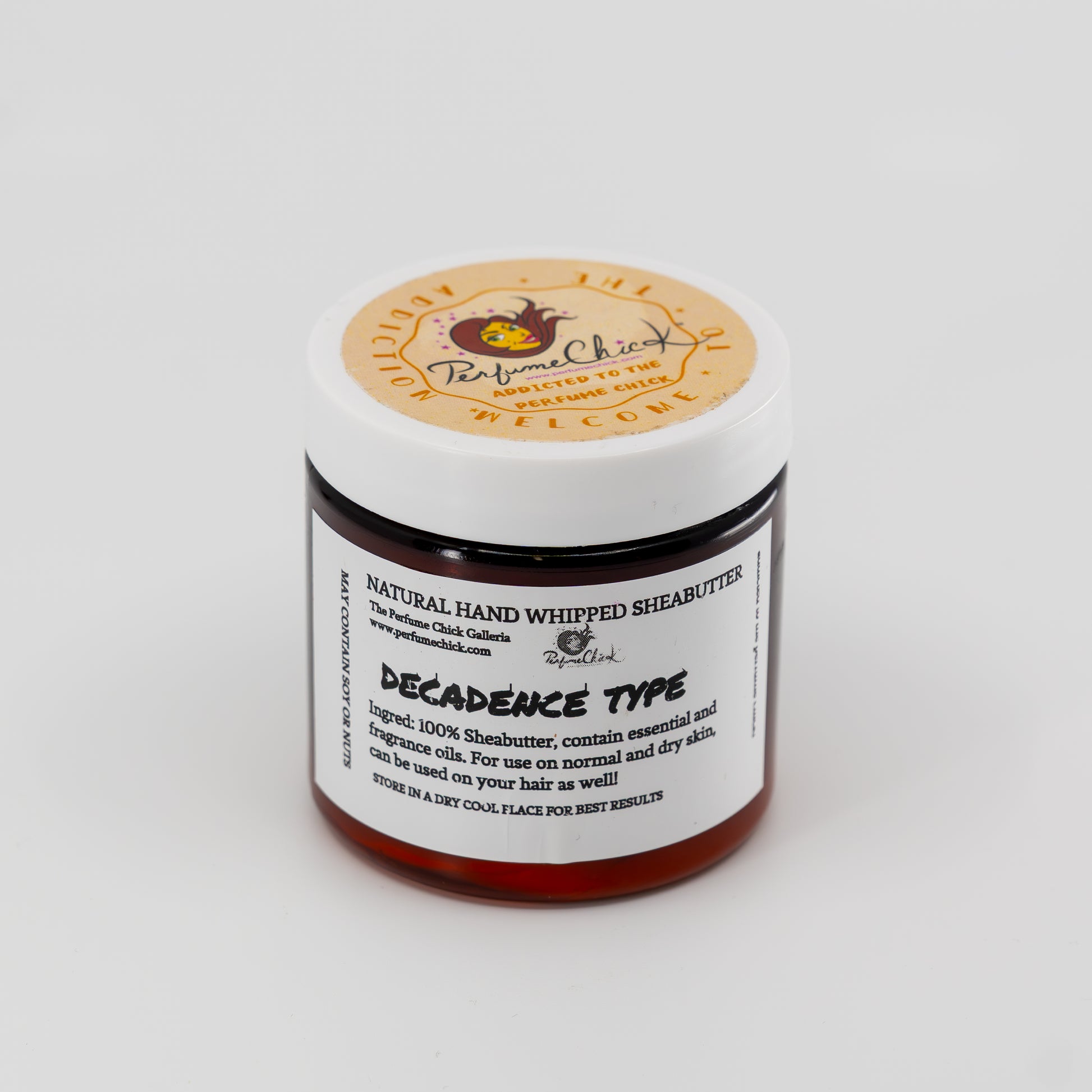 Jar of natural hand whipped shea butter with a label on a white background