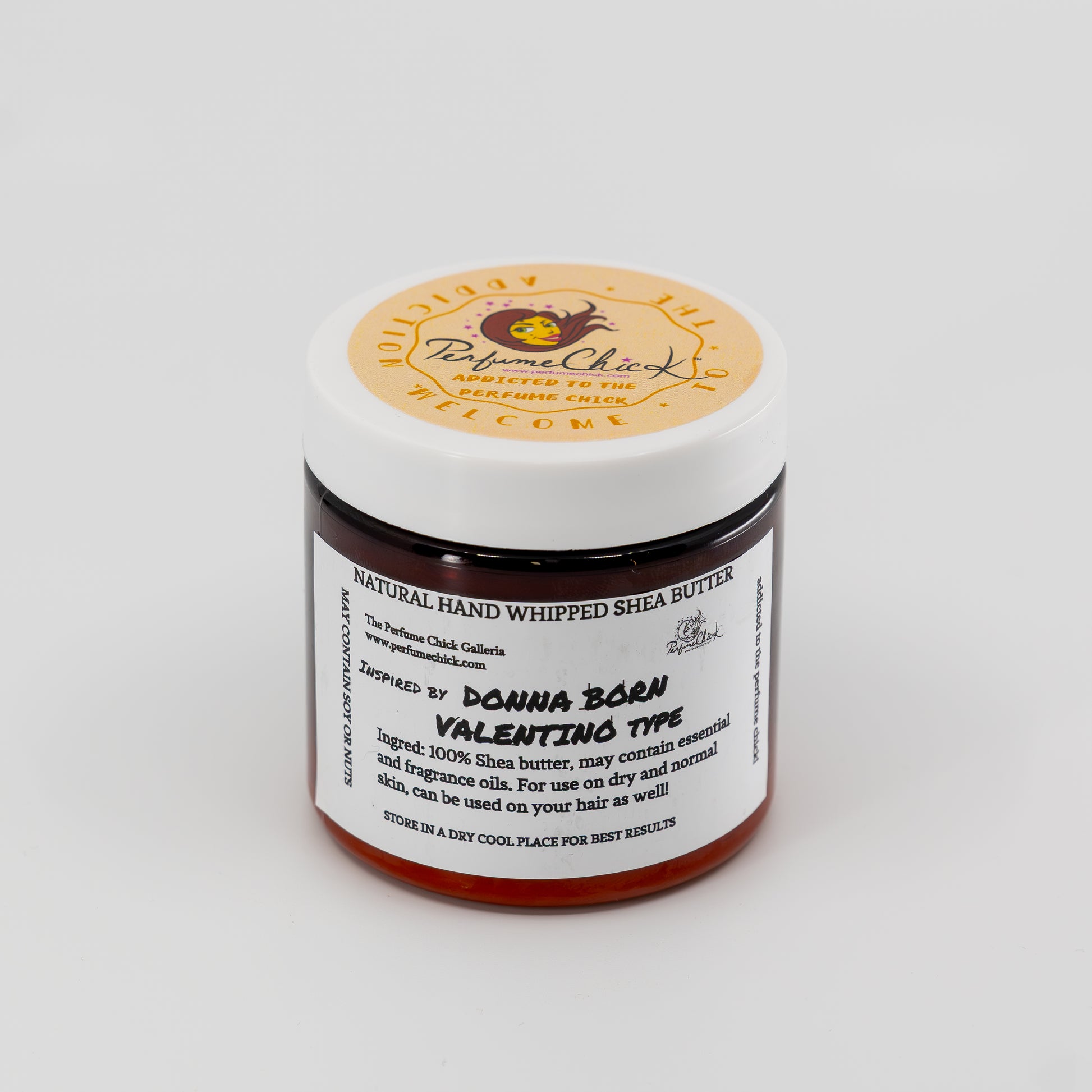 Jar of natural hand whipped shea butter with a visible label on a white background