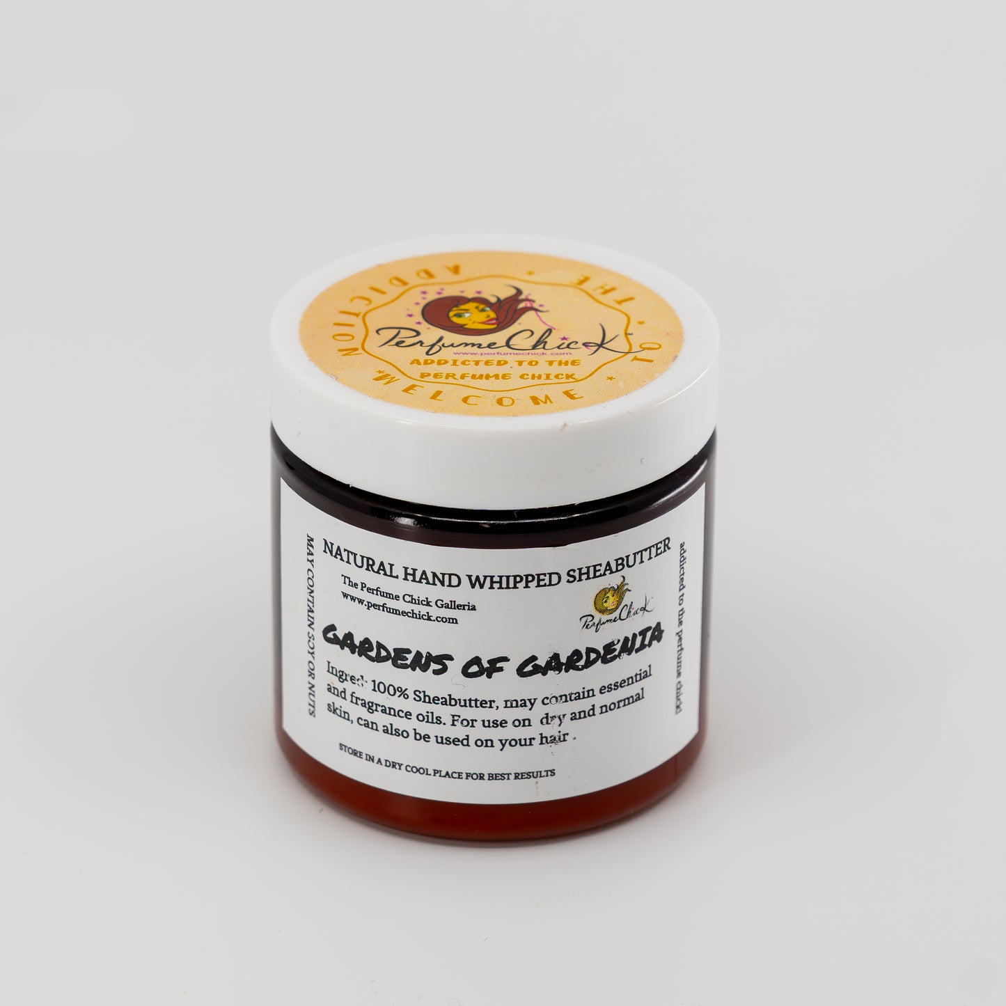 Jar of natural hand whipped shea butter with a visible brand label on a white background