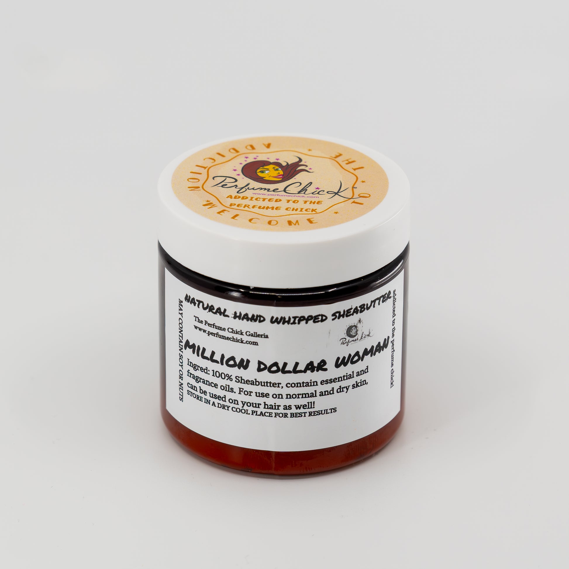 Jar of natural hand whipped shea butter with a label on a white background
