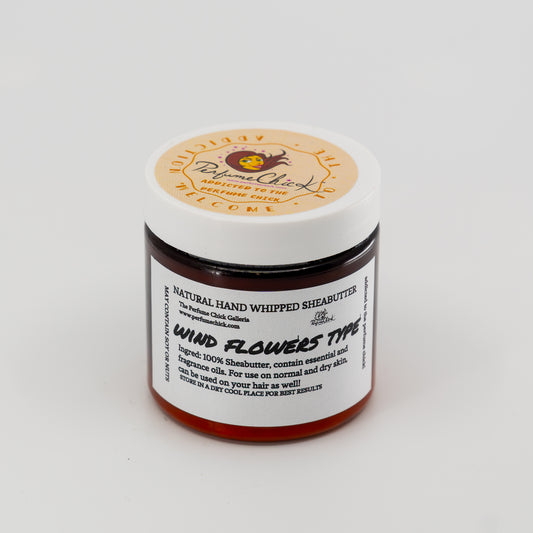 Jar of natural hand whipped sheabutter with a white label on a light gray background